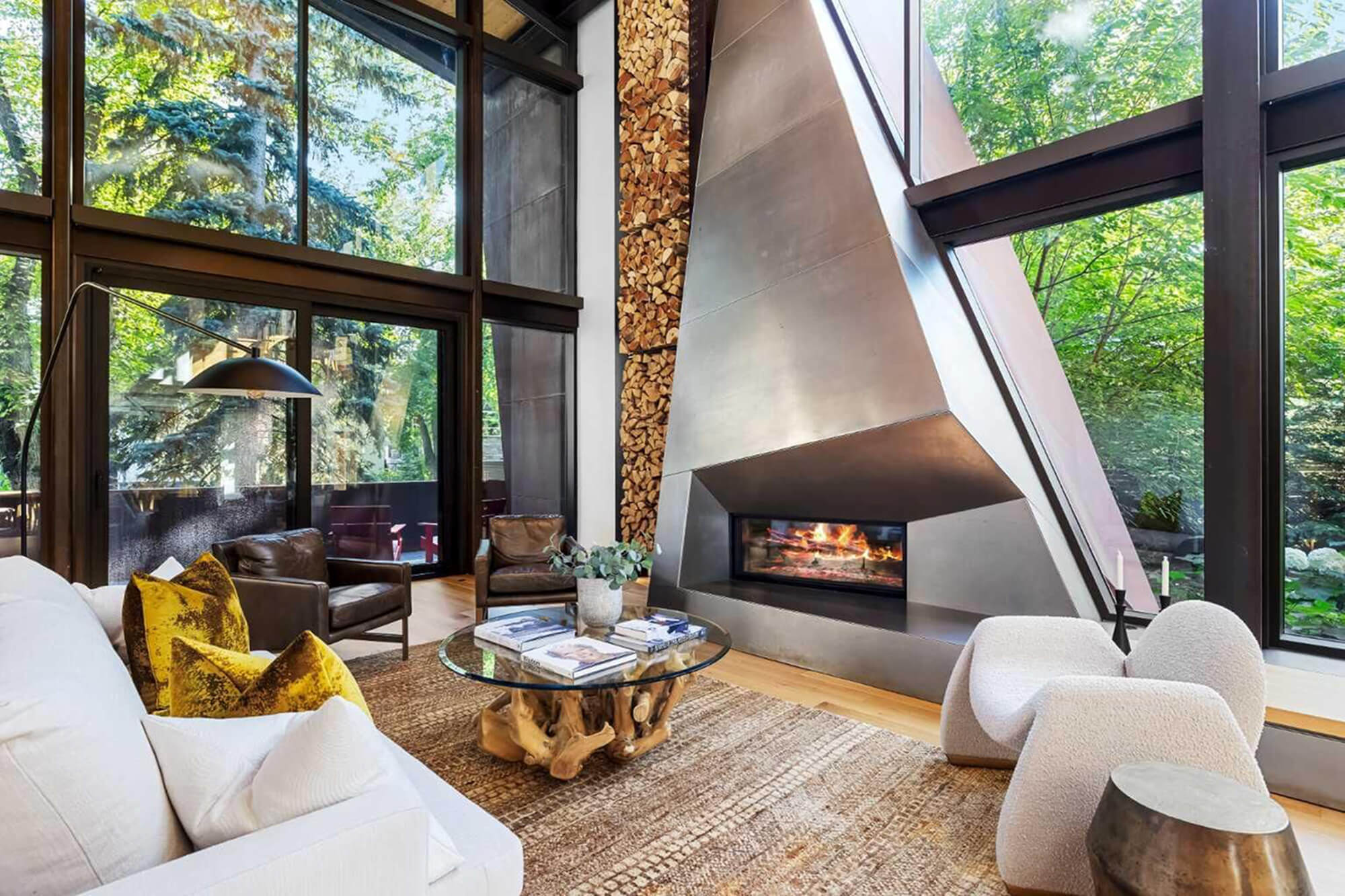 Modern living room with a fireplace and tall windows